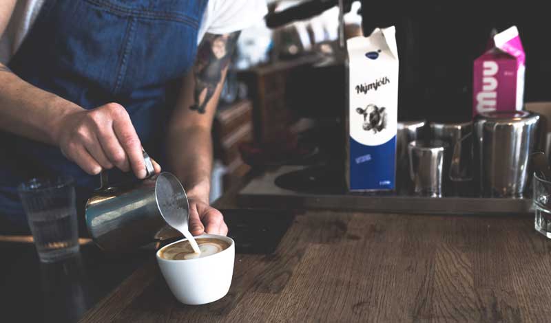 Barista pouring a latte